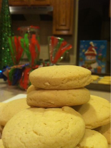 a stack of cookies sitting on top of a counter next to a christmas tree in the background