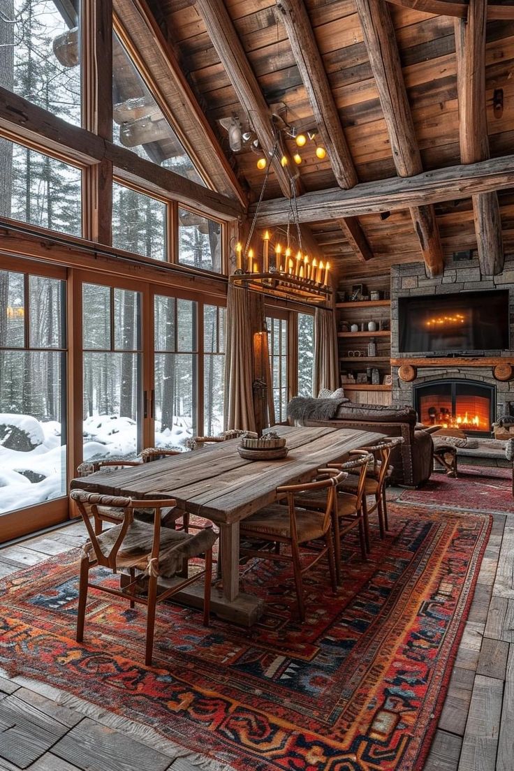 a dining room with a table and chairs in front of a fire place inside of a log cabin