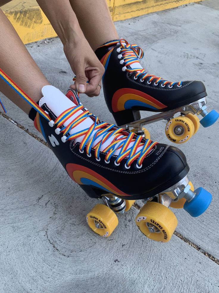 the skateboarder is tying his shoelaces to their rollerblading shoes