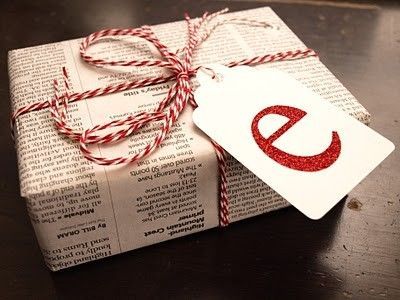 a gift wrapped in paper and tied with twine, sitting on top of a table