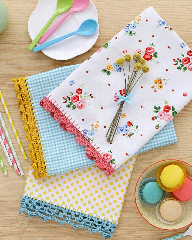 the table is set with colorful napkins, plates and utensils on it