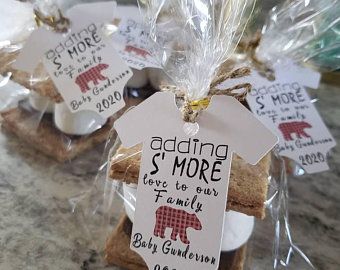 some cookies are wrapped in plastic and sitting on a counter top with tags attached to them