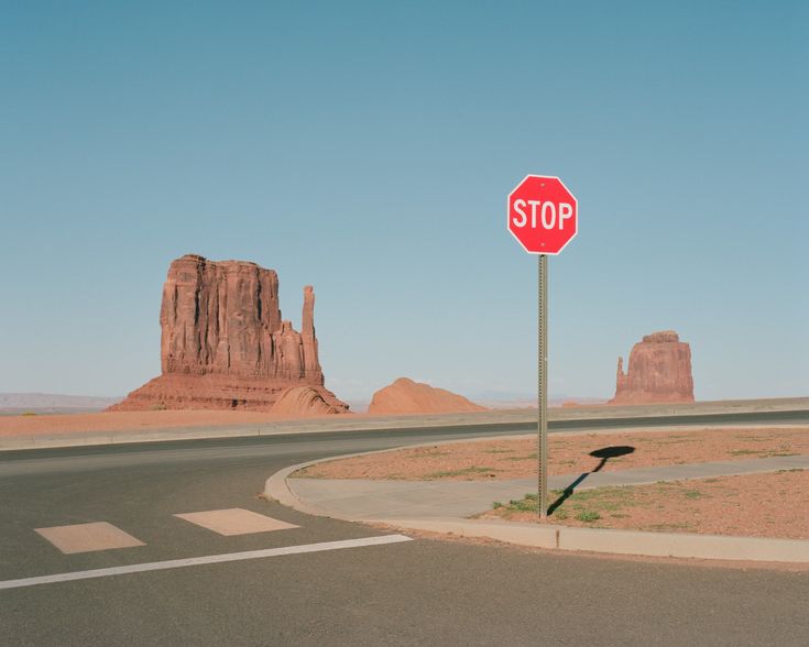 a stop sign at an intersection in the desert