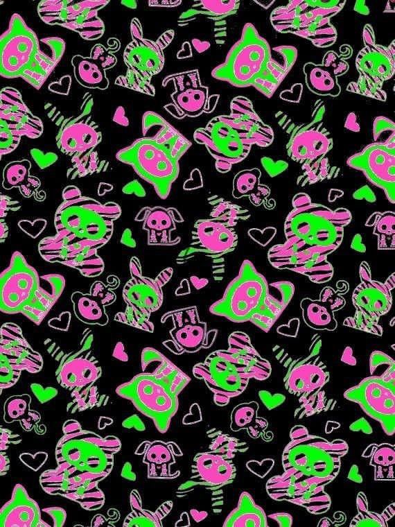 a black background with pink and green skulls