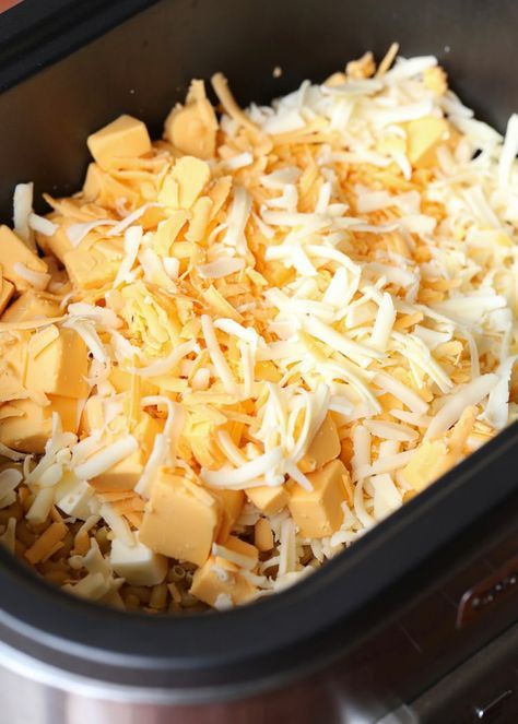 shredded cheese is in the crock pot on the stove top, ready to be cooked