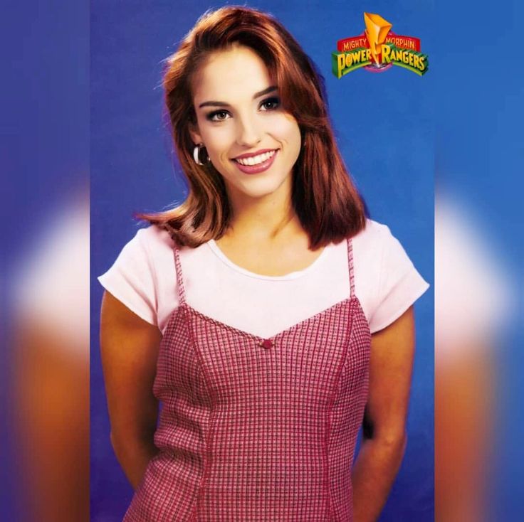 an image of a woman smiling in front of a blue background with the name power rangers on it