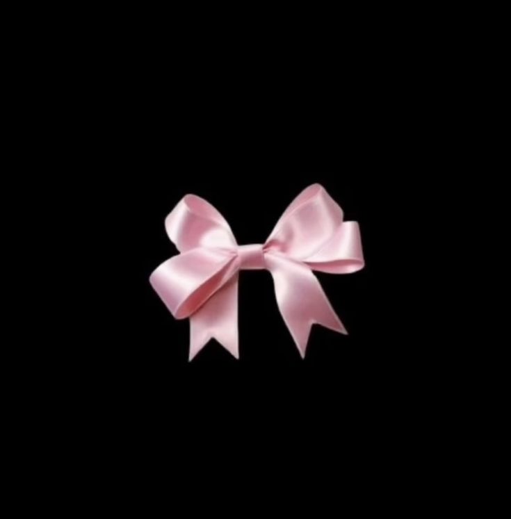 a pink bow on a black background