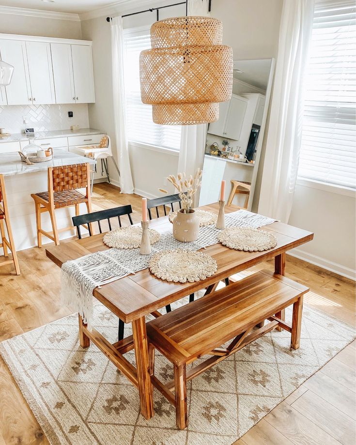 a dining room table with chairs and a bench