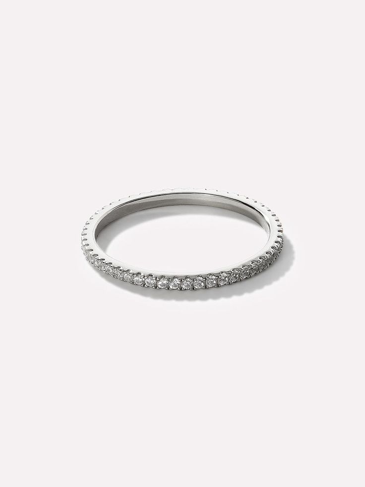 Eternity Ring - Céline Silver Classic Eternity Band With Halo For Gift, Classic Eternity Band With Halo Detail As A Gift, Classic Eternity Band With Halo As A Gift, Timeless Round Stackable Rings, Classic Vvs Clarity Eternity Band, Modern Stackable Half Eternity Rings, Modern Silver Stackable Rings With Prong Setting, Modern Stackable Eternity Band In White Gold, Modern Round Eternity Band For Promise