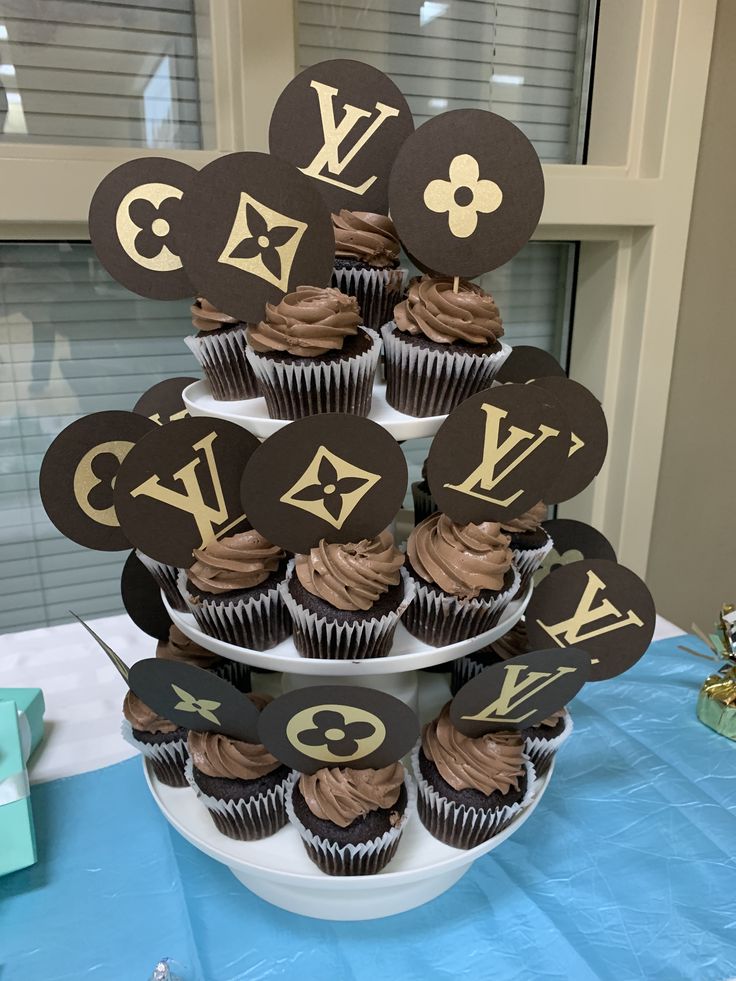 cupcakes are arranged in the shape of louis vuitton's initials