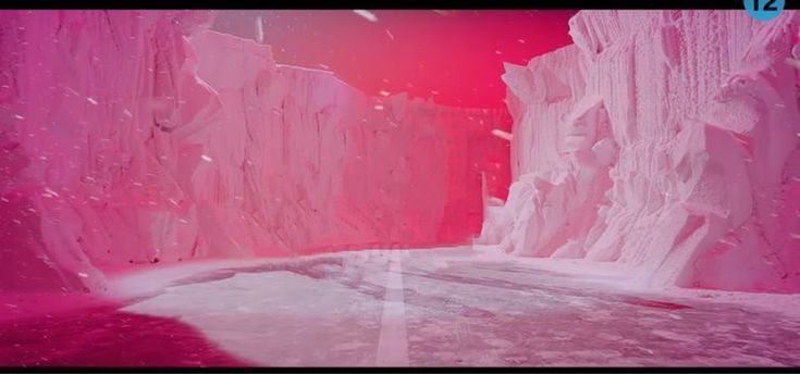 an abstract photo of ice formations in pink and red colors, with snow falling off the ground