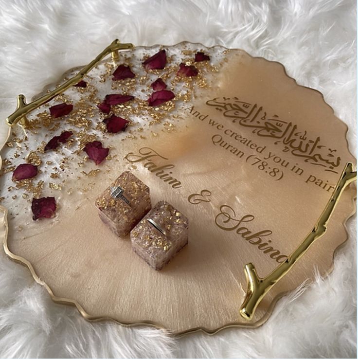 two pieces of jewelry sitting on top of a white furnishing covered floor next to a sign