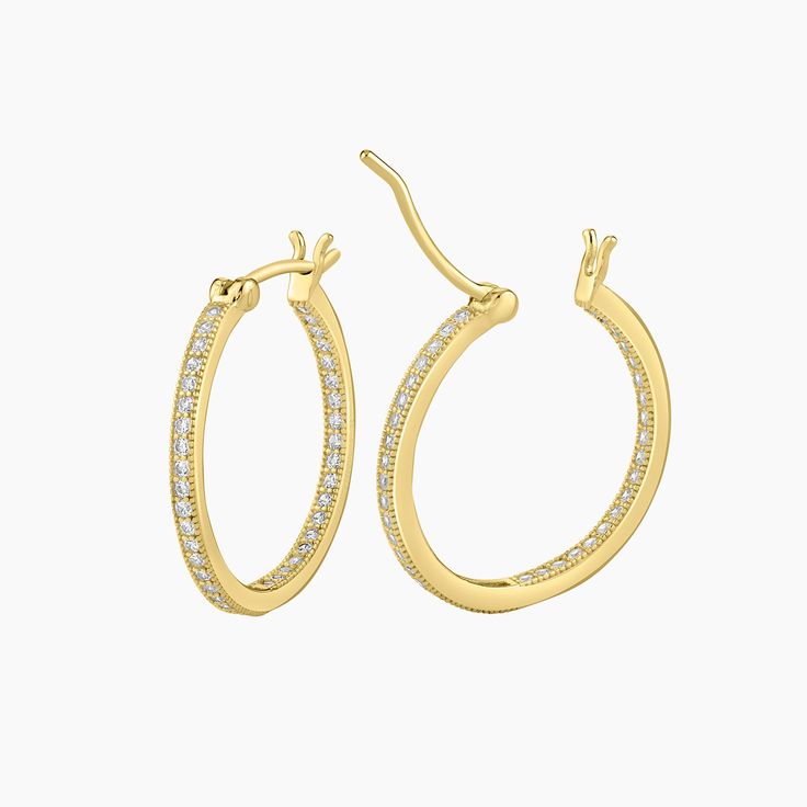 These elegant Gold plated sterling silver inside out micro pave cubic zirconia hoop earrings showcase a striking design that combines style and comfort. The hoop earrings feature a round wire-shaped bar, providing maximum comfort when worn. The inside out design ensures that the shimmering CZ stones are visible from both the front and the inner curve, creating a stunning visual effect. A timeless addition to any jewelry collection, suitable for both casual and formal occasions. 20mm diameter. Luxury Small Hoop Earrings For Parties, Luxury Small Hoop Earrings For Formal Events, Luxury Pave Setting Hoop Earrings For Everyday, Macy's Luxury Fine Jewelry Hoop Earrings, Luxury Gia Certified Fine Hoop Earrings, Luxury Minimalist Hoop Earrings With Pave Setting, Luxury Round Hoop Earrings With Pave Setting, Macy's Luxury Small Hoop Earrings, Luxury Women's Hoop Earrings With Pave Setting