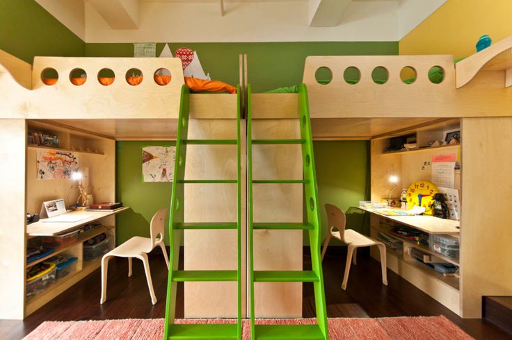 a room with bunk beds, desks and shelves on the walls is decorated in green