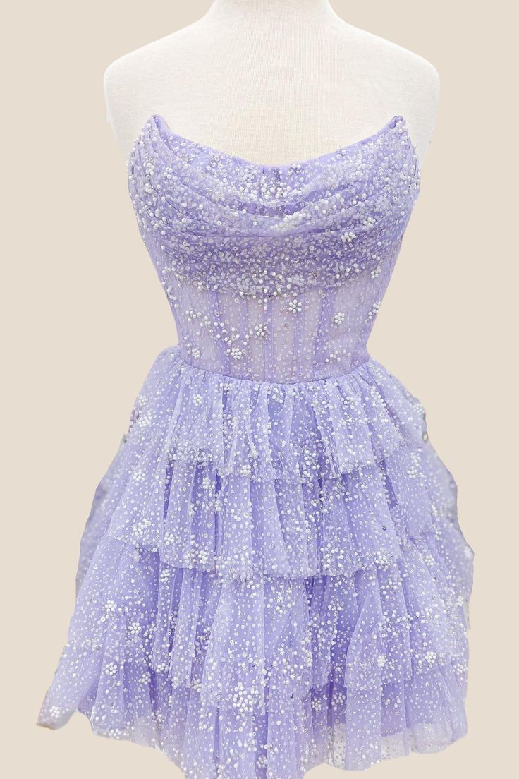 This dress features a beautiful Lavender color and is made from Tulle material, making it lightweight and airy. The A-line silhouette is flattering and the Corset bodice with strapless neck adds support and style. The skirt is designed with tiered ruffles for a playful touch, and the back zips up for convenience. Perfect for any party, this dress falls above the knee for a fun and flirty look. Classy Homecoming Dress, Short Princess Dress, Cute Formal Dresses, Dama Dresses, Tulle Homecoming Dress, Short Party Dress, Corset Bodice, Formal Dresses Short, Pretty Prom Dresses