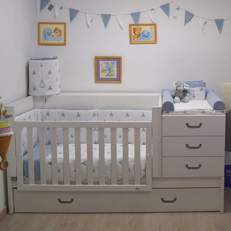 a baby's room with a crib and dresser