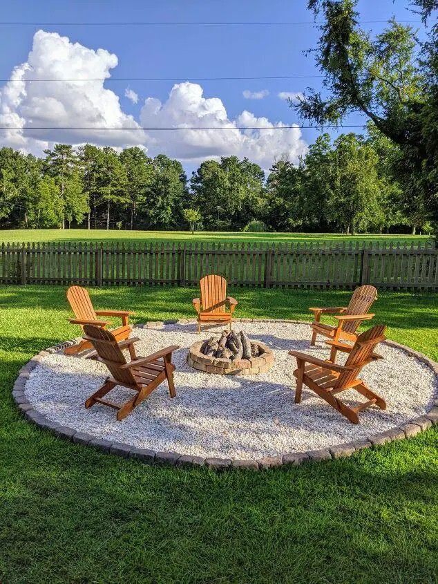 an outdoor fire pit with chairs around it