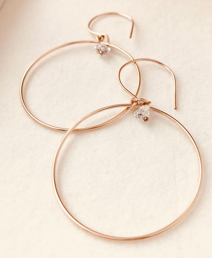 Just as effortless as they are simple, these hoop earrings are an essential everyday piece. Item Details: • This listing is for A PAIR ( 2 pieces ) earrings.• All metal is components are sterling silver and 14k gold-fill• Hoops measure 40mm in diameter.• Herkimer quartz crystals prized, each Herkimer diamond is a natural entity and no stone is identical.• The order will arrive in a gift-wrapped box and free polishing cloth. It will be ready for gift giving. All our work is custom-made by hand in Delicate Sterling Silver Hoop Earrings In Yellow Gold, Delicate Hoop Earrings In Yellow Gold And Sterling Silver, Delicate Yellow Gold Sterling Silver Hoop Earrings, Dainty Hoop Earrings With Simple Design For Everyday, Minimalist 14k Gold Hoop Earrings For Everyday, Everyday Tarnish Resistant Rose Gold Hoop Earrings, Everyday Rose Gold Tarnish Resistant Hoop Earrings, Minimalist Rose Gold Hoop Earrings For Everyday, Everyday Tarnish-resistant Rose Gold Hoop Earrings