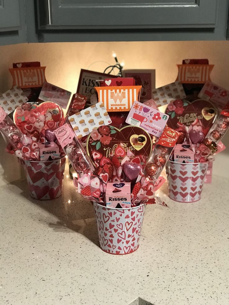 valentine's day gift baskets with candy and candies in them on a kitchen counter