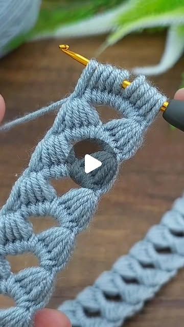 someone crocheting an object with yarn on the table