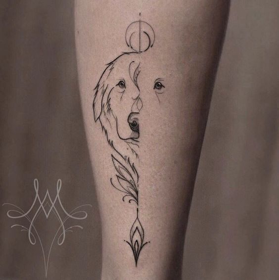 a woman's leg with a tattoo on it and a wolf head in the middle