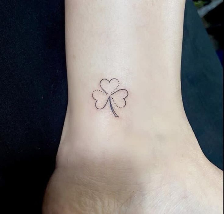 a small four leaf clover tattoo on the ankle