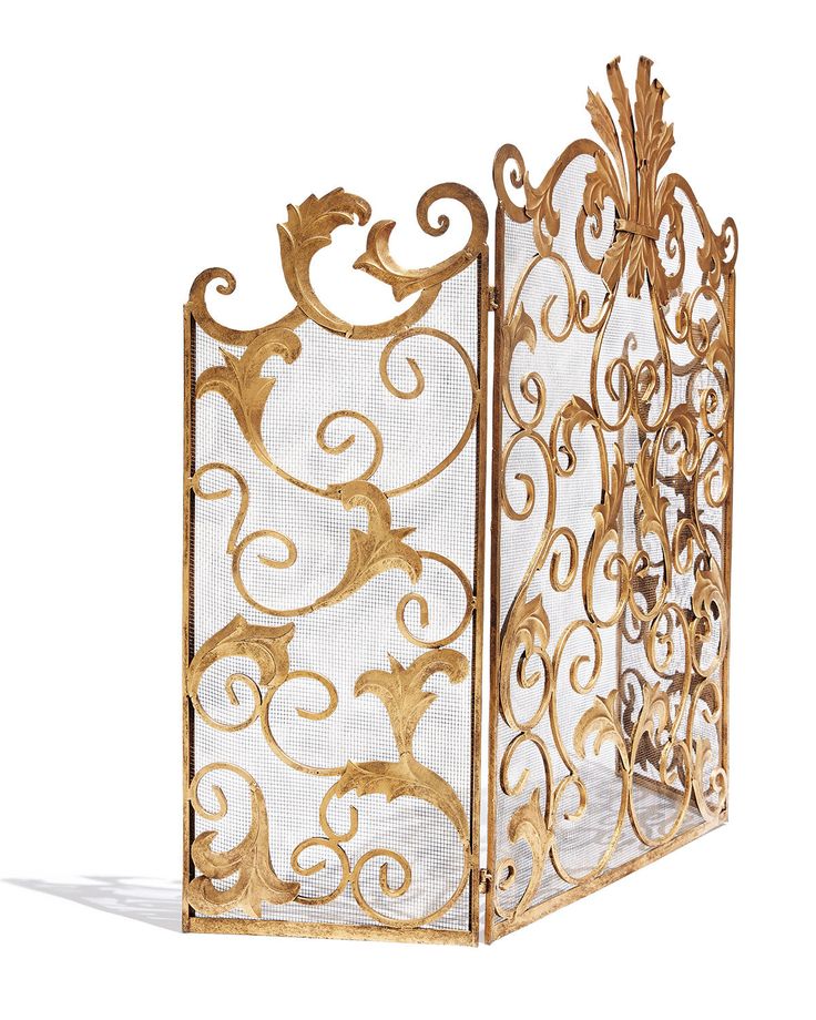 an ornate gold and white fireplace screen with scroll work on the sides, set against a white background