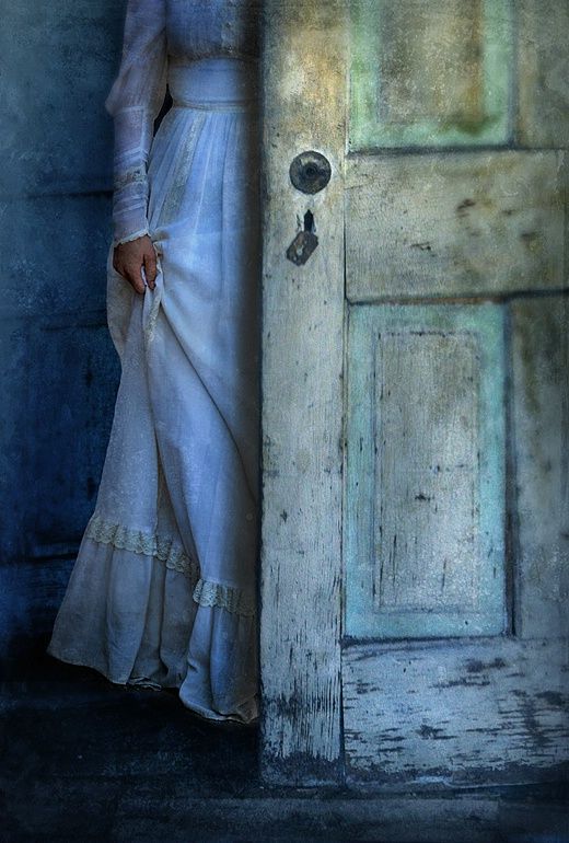 a woman standing in front of a door