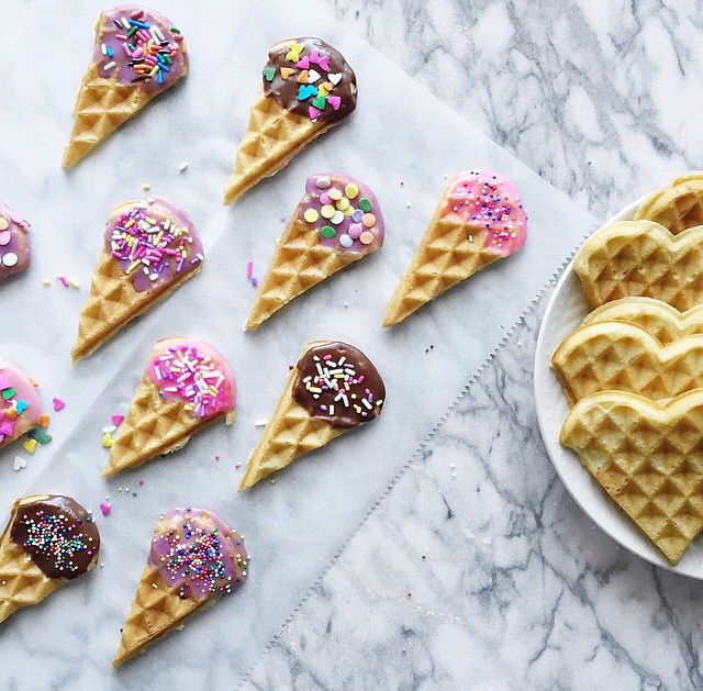 several waffles with chocolate and sprinkles are arranged in the shape of hearts