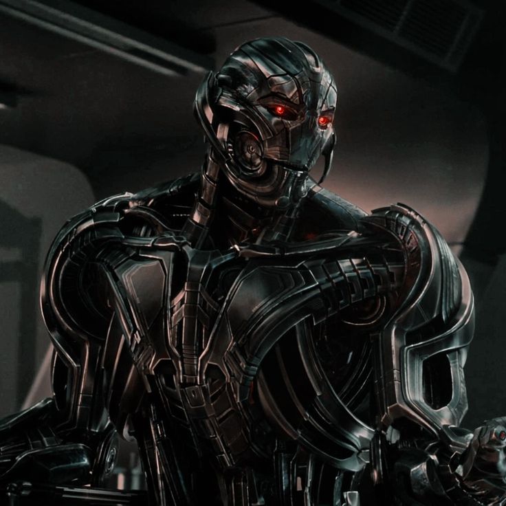 an image of a robot that is standing in the dark knight armor with red eyes