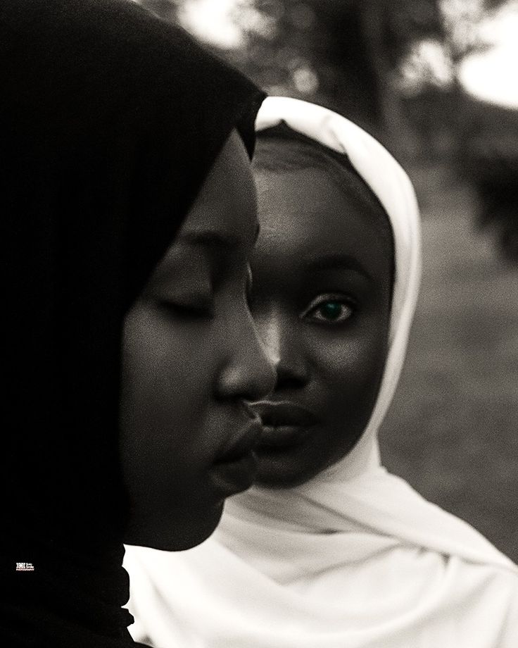 two women in headscarves are looking at each other