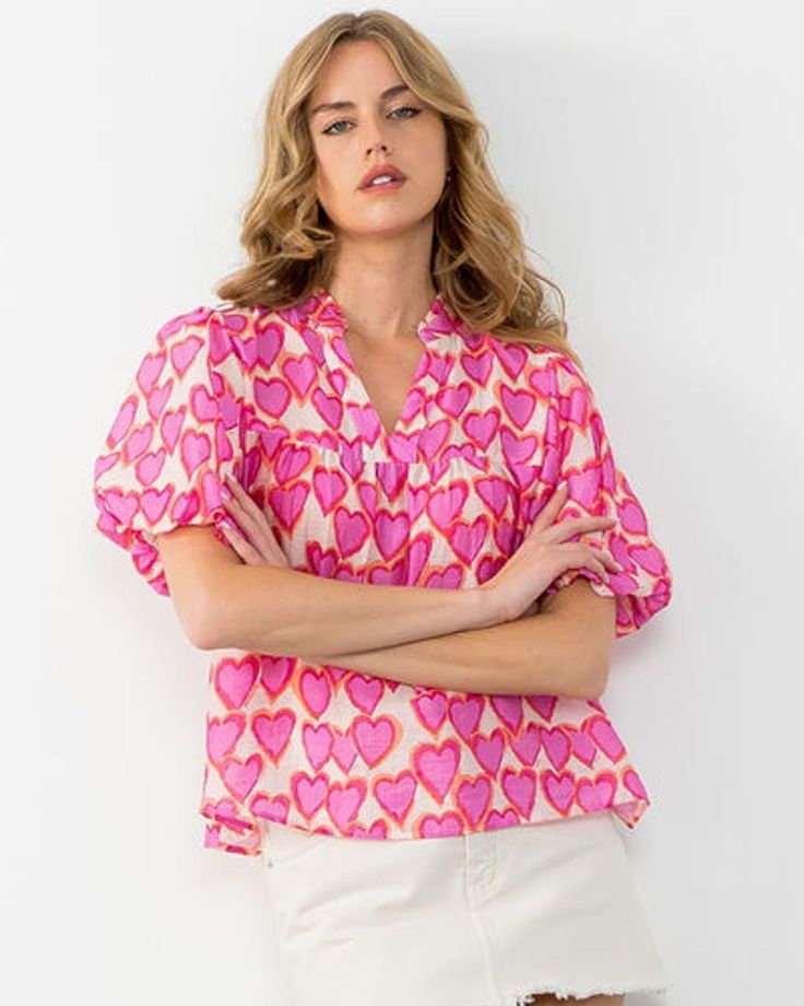 Get hearts racing with this playful Heart Puff Sleeve Blouse. Featuring a charming heart print and flirty puff sleeves, this top adds a touch of whimsy to any outfit. Perfect for those who don't take themselves too seriously, this blouse is sure to turn heads with its quirky style. #kardenlane #onlineboutique #thewoodlandsboutique #clothesforvalentinesday Valentines Collection, Cream Trousers, Heart Top, Heart Dress, Happy Heart, Puff Sleeve Blouse, Puff Sleeve Top, The Chic, Heart Print