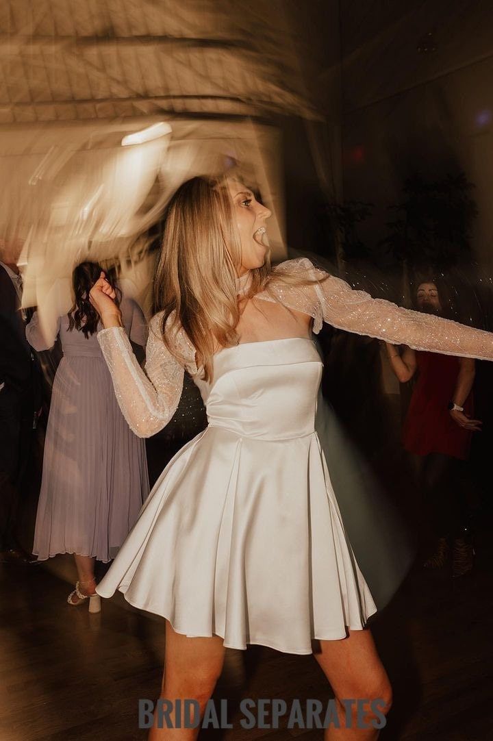 a woman in a white dress is dancing