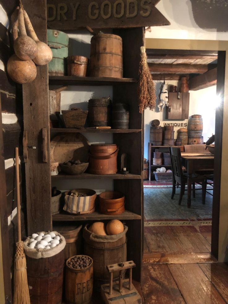 an old wooden shelf filled with lots of pots and pans