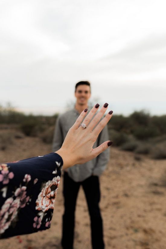 two people standing in the desert with their hands out