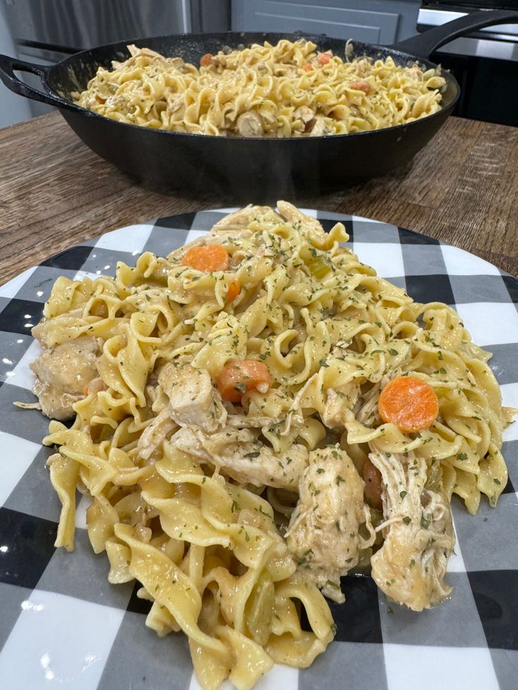 two plates of food on a table with a skillet in the backgroud