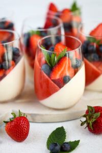 dessert with fruit in glasses and strawberries on the side