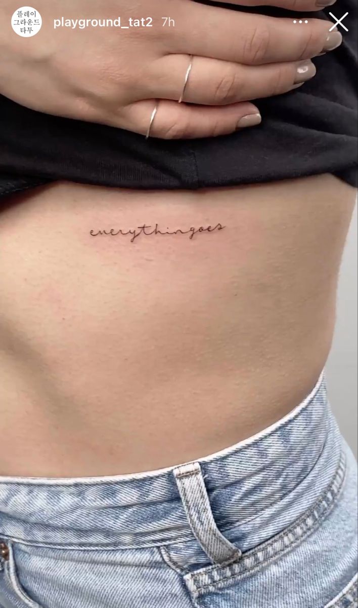 a woman's stomach with the word happiness tattooed on her lower side ribcage