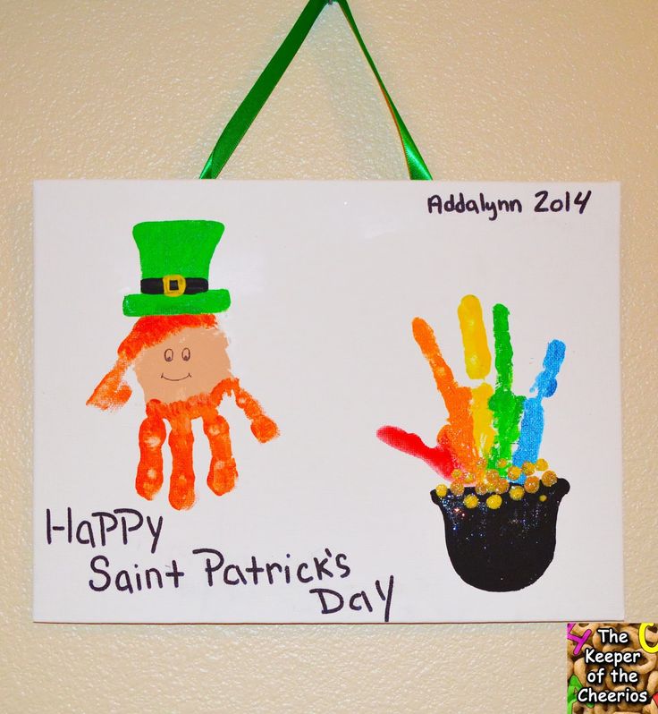 a st patrick's day sign hanging on the wall with handprints of two hands and a pot of gold coins