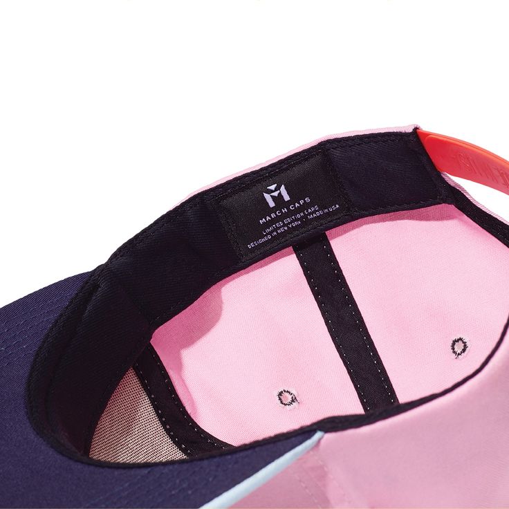 The Blinky is a classic six-panel, baseball-style cap in pink with a contrasting light blue brim and raised embroidery detail in orange. All March Caps feature top eyelets and an adjustable snap-back closure. Each cap comes with a hand-numbered card signed by the designer. Pink Sports Hats With Embroidered Logo, Pink Visor Baseball Cap With Embroidered Logo, Pink Snapback Baseball Cap With Embroidered Logo, Pink Baseball Cap With Embroidered Logo, Pink Embroidered Snapback Baseball Cap, Trendy Pink Baseball Cap With Embroidered Logo, Pink Snapback Dad Hat For Summer, Pink Six-panel Cotton Baseball Cap, Pink Adjustable Curved Visor Hat