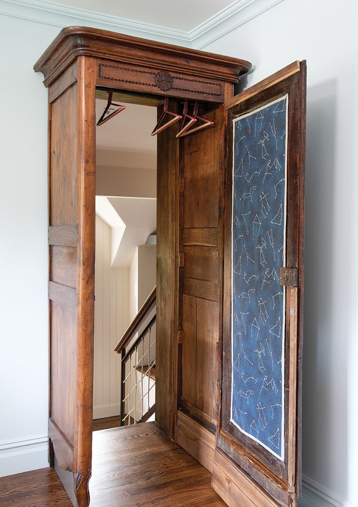 an open wooden door in the middle of a room