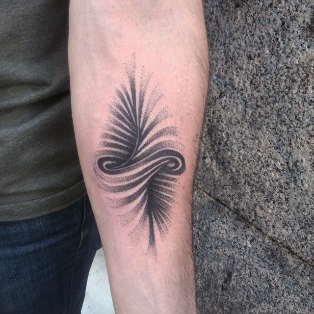 a person with a tattoo on their arm that has an image of a wave coming out of it