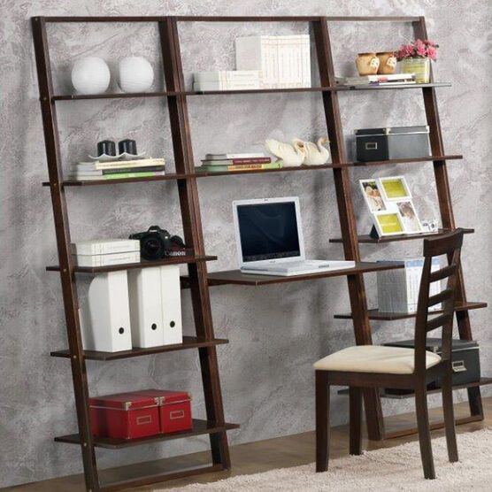 a computer desk with a laptop on top of it next to a book shelf filled with books