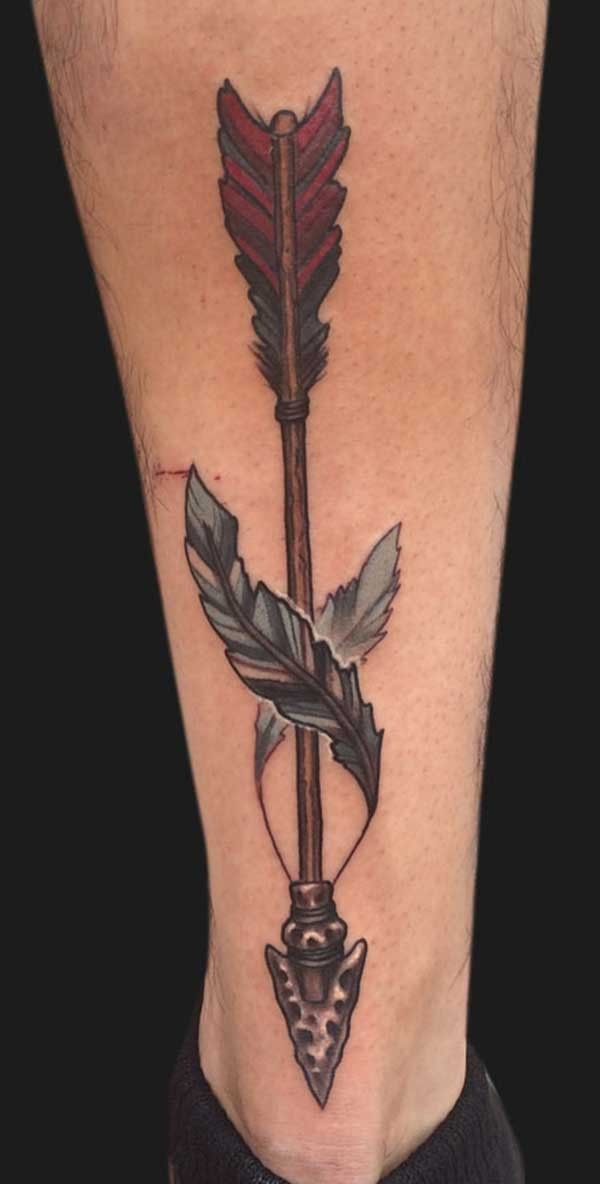 a man's foot with a tattoo on it and an arrow in the middle