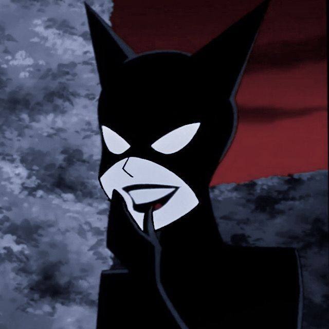 the animated batman is standing in front of a red and black flag with his mouth open