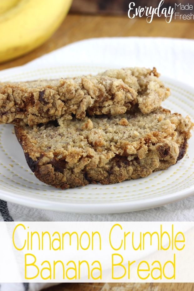 two slices of cinnamon crumble banana bread on a white plate with bananas in the background