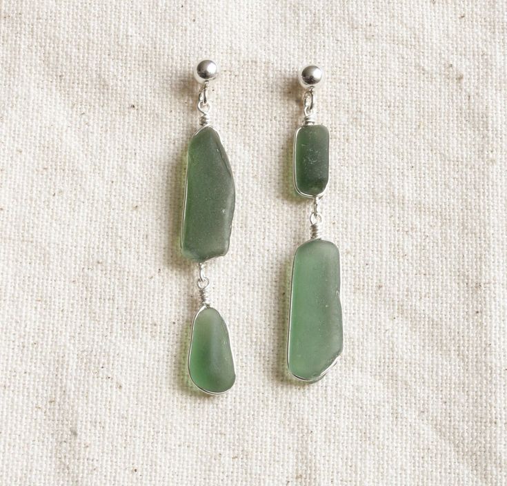 Earrings made with green glass shards collected in Lake Léman, Switzerland. The wire and earring studs (with a 3mm sphere) are made in Sterling silver. Assembled by hand. Green Dangle Earrings In Recycled Glass, Green Recycled Glass Dangle Earrings, Green Dangle Earrings With Recycled Glass, Green Wire Wrapped Long Drop Earrings, Minimalist Green Glass Jewelry, Handmade Sea Glass Green Earrings, Green Sea Glass Earrings With Ear Wire, Green Wire Wrapped Long Drop Jewelry, Green Sea Glass Earrings For Gift