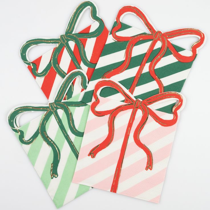 three christmas gift tags with bows and ribbons on them, all decorated in different colors