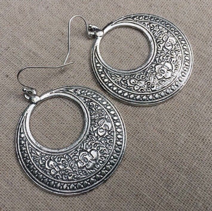 "These are fabulous and chic boho floral hoop earrings!  Make a statement without saying a word with these versatile earrings.  Perfect for everyday wear, dress them up or down! The hoops measure 1 5/8\" long by 1 1/2\" wide.  They hang from simple silver ear wire hooks.  Overall drop length is just under 1 3/4\".  Made from plated silver. I have this same earring style also available in gold. Here is a direct link to those... https://www.etsy.com/listing/1524279410/ Thanks so much for stopping Silver Boho Earrings, Big Silver Earrings, Big Dangle Earrings, Bohemian Flower, Boho Hoop Earrings, Statement Hoop Earrings, Earrings Big, Statement Drop Earrings, Disc Earrings