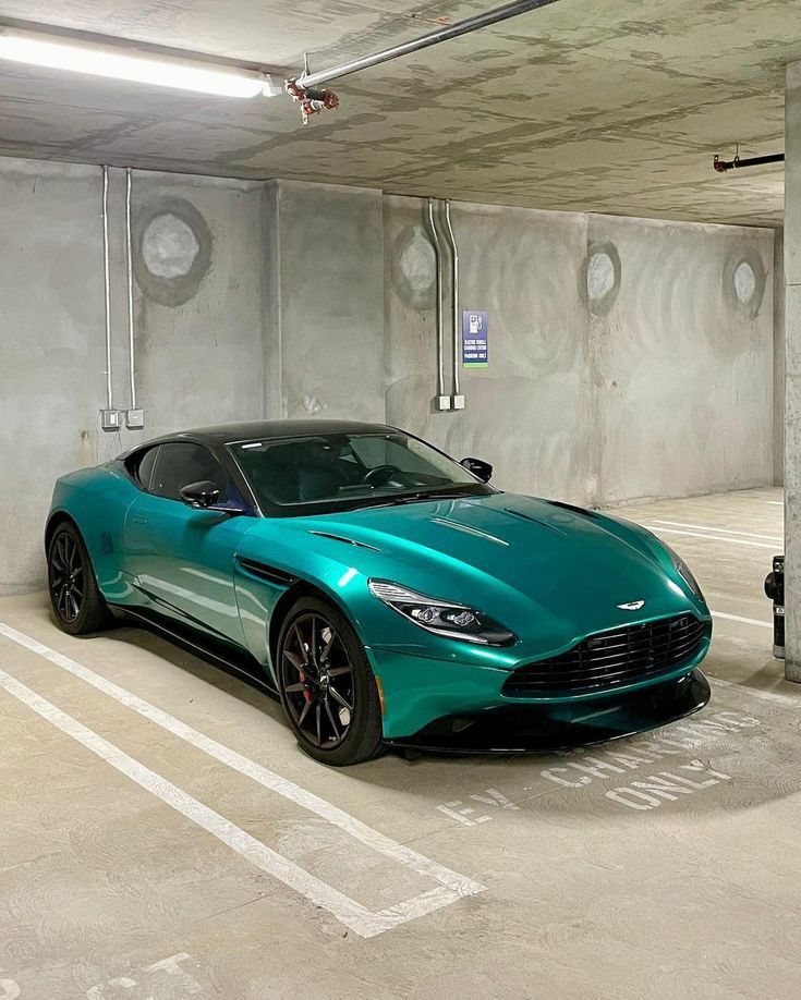 a blue sports car parked in a parking garage with no one around it or on the ground